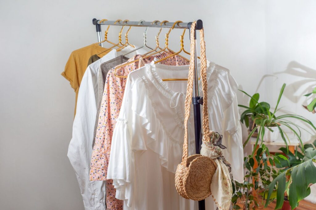Comment gérer les bouffées de chaleur au bureau ? 1 Des vêtements sur un portant pour suggérer comment gérer les bouffées de chaleur au bureau.
