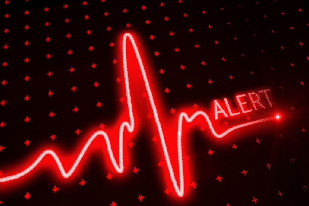 une courbe lumineuse rouge sur un fond noir avec le mot alerte en rouge
