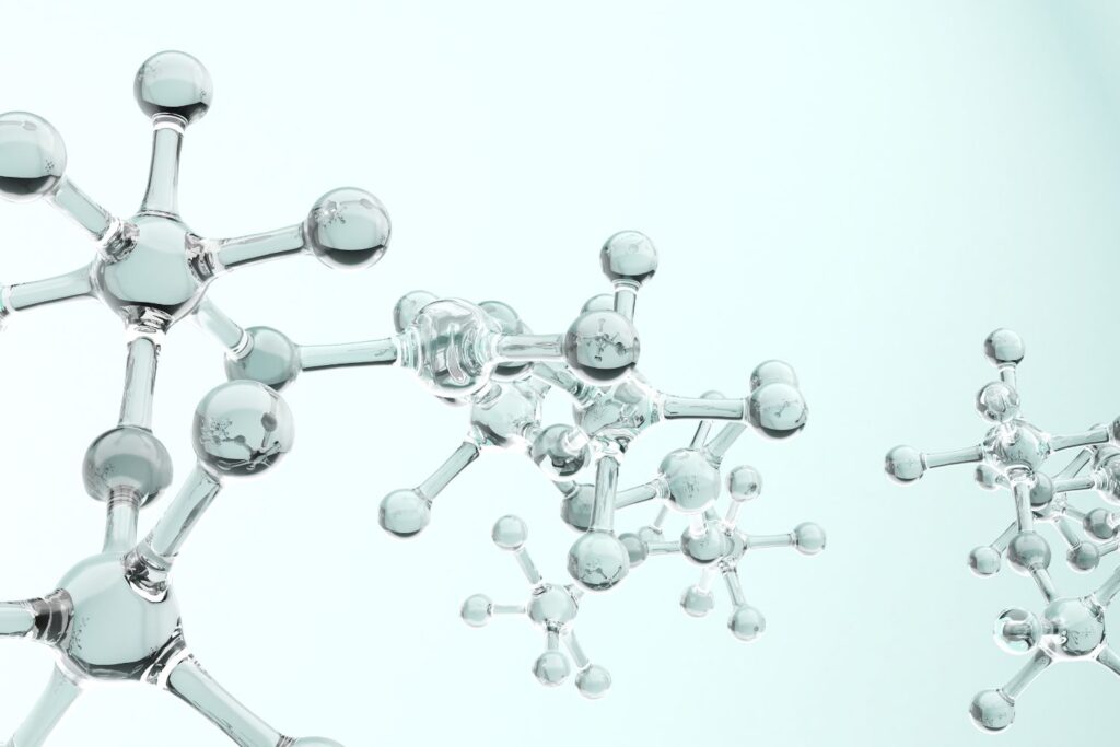 Des atomes translucides sur fond gris pour illustrer l'article sperme de saumon en injection.